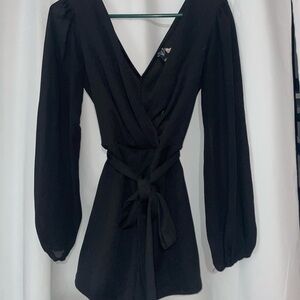 Black long sleeve, v neck romper with a tie